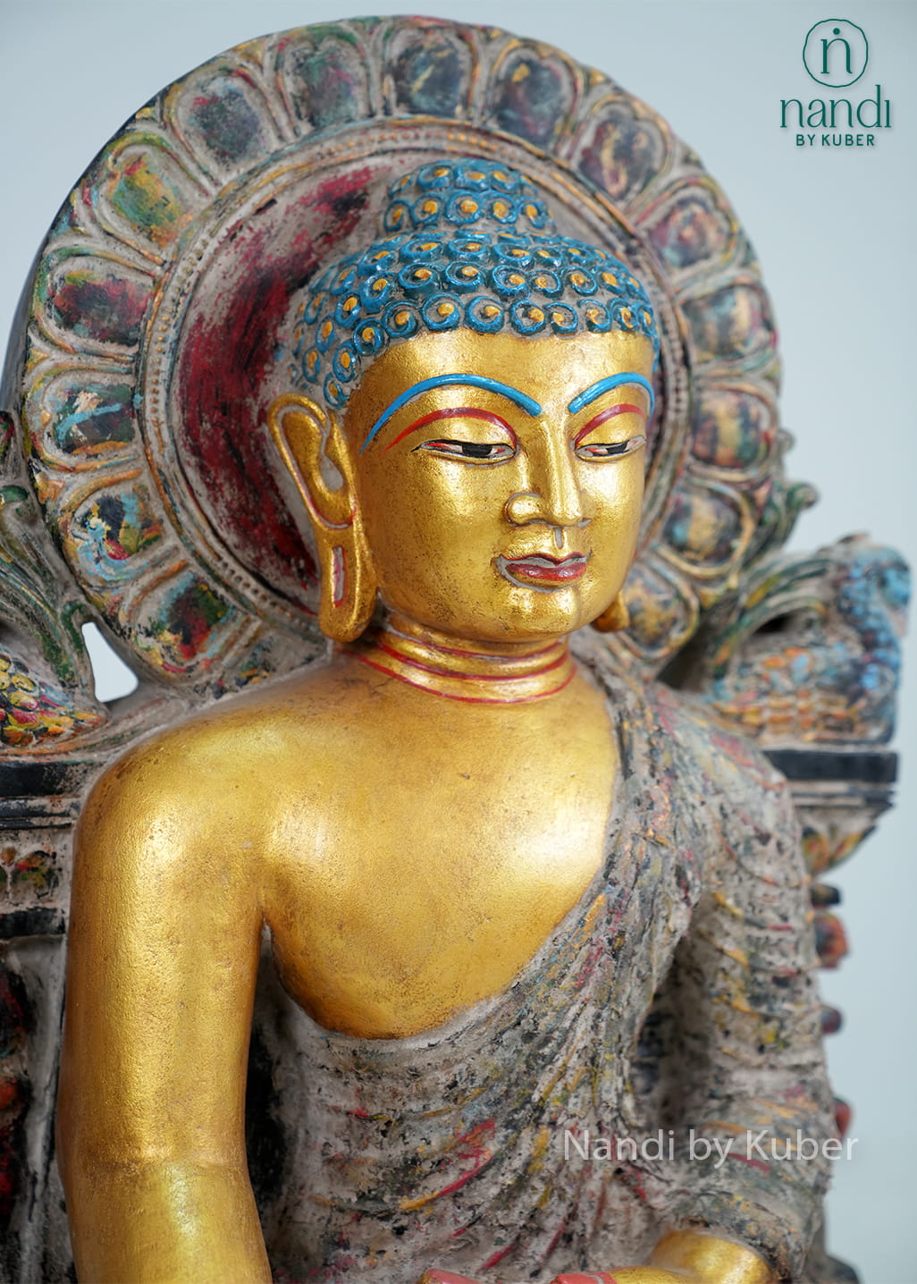 Antique-finish seated Buddha statue with gold-tone detailing, ornate arch backdrop, and handcrafted decorative artistry.