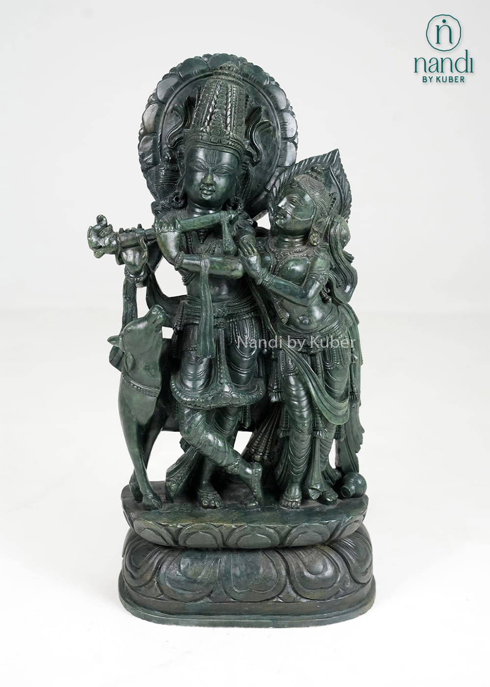 Stone Radha Krishna statue with cow and intricate detailing