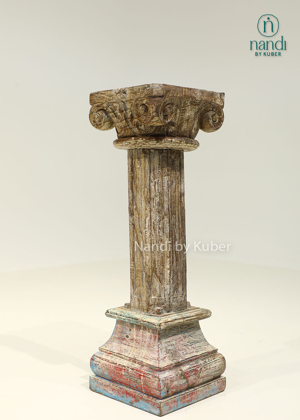 Antique-style handcrafted wooden pillar with distressed detailing and carved accents, perfect for displaying decorative objects and enhancing interior décor.