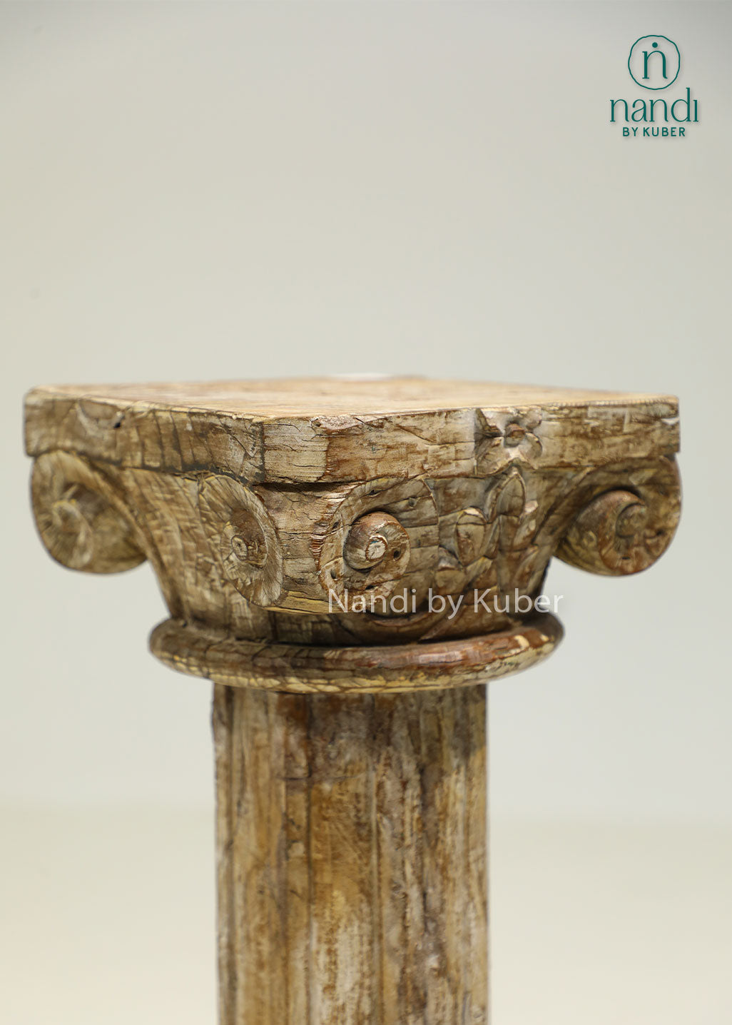 Antique-style handcrafted wooden pillar with distressed detailing and carved accents, perfect for displaying decorative objects and enhancing interior décor.