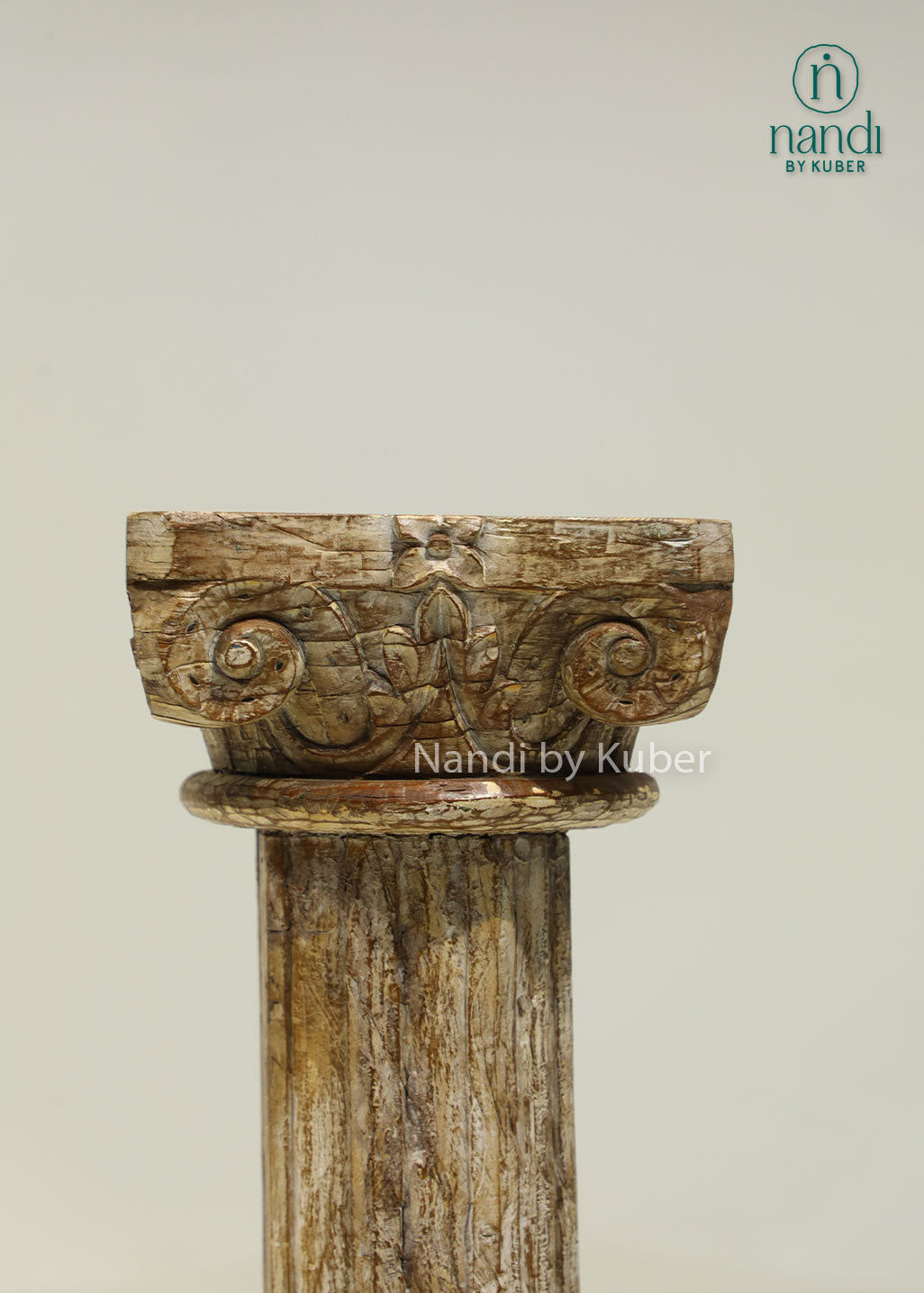 Antique-style handcrafted wooden pillar with distressed detailing and carved accents, perfect for displaying decorative objects and enhancing interior décor.