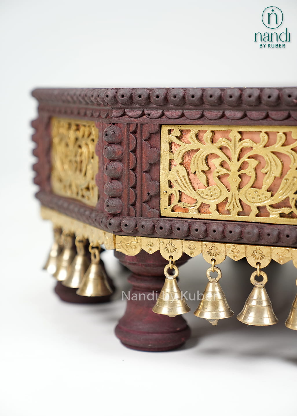 Octagonal wooden pooja chowki with brass detailing and bell accents