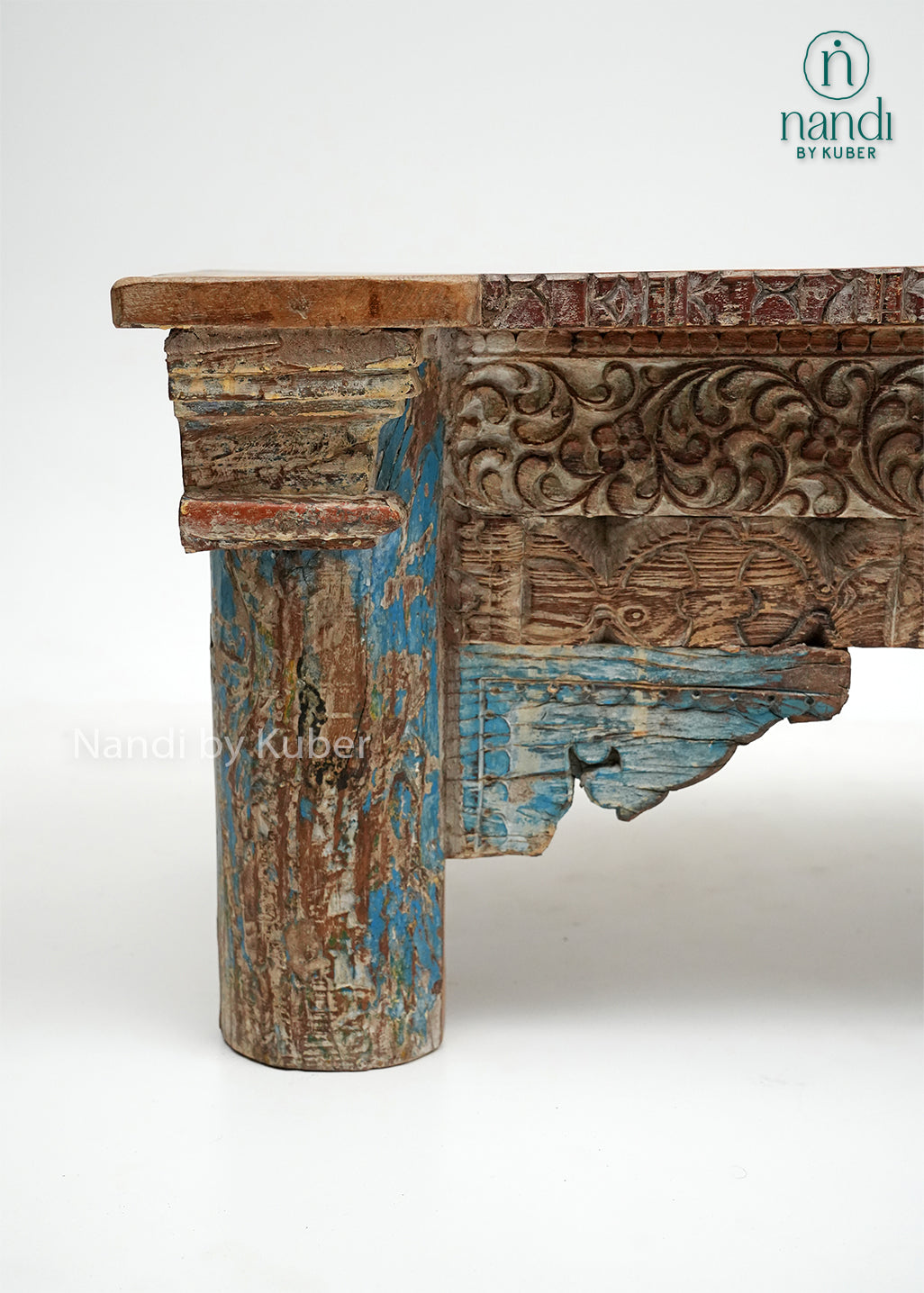 Rustic handcrafted wooden console table with intricate carvings and vintage detailing, perfect for adding character and elegance to any interior space.