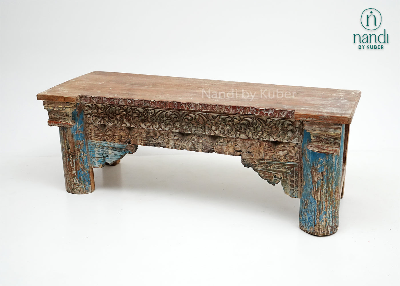 Rustic handcrafted wooden console table with intricate carvings and vintage detailing, perfect for adding character and elegance to any interior space.