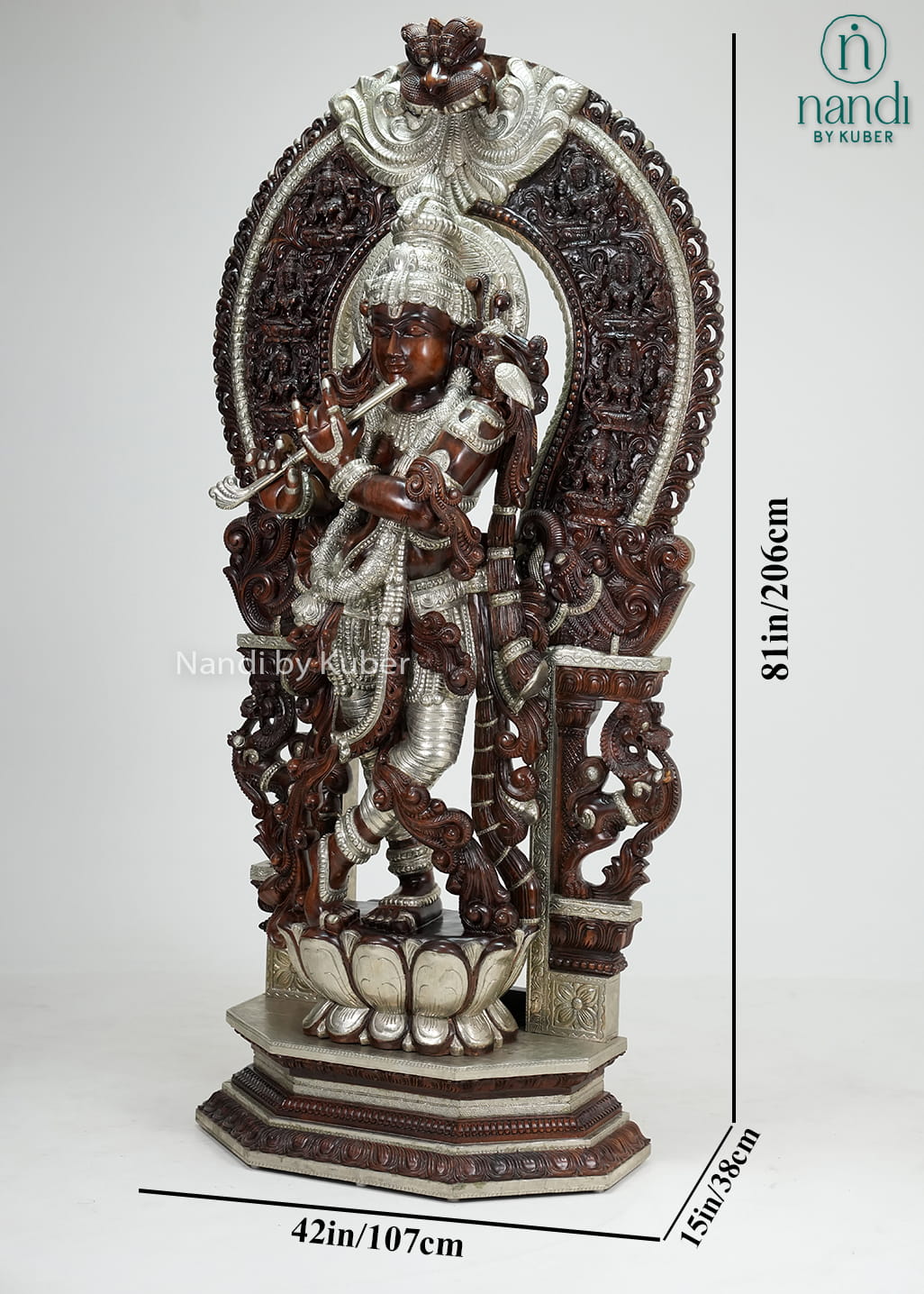 Wood-tone and ivory-finish Lord Krishna statue with ornate carved arch, flute, and decorative pedestal base.