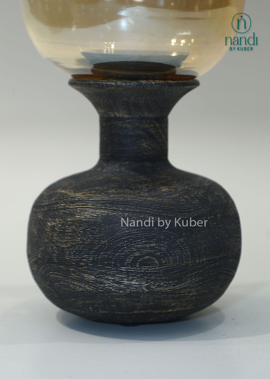 Wooden matka candle holder with amber glass shade, handcrafted decorative candle stand for home décor, table centerpiece, ambient lighting, festive decoration, rustic interiors, and elegant living spaces.