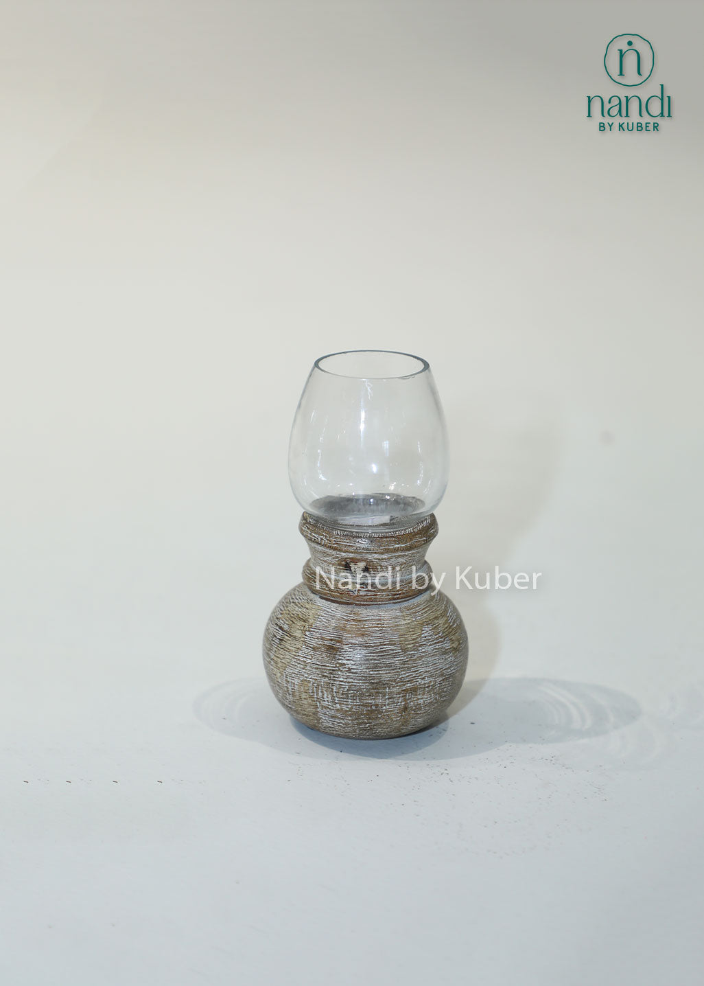 Wooden matki candle holder with clear glass shade, handcrafted decorative candle stand for home décor, table centerpiece, ambient lighting, festive decoration, rustic styling, and elegant living spaces.