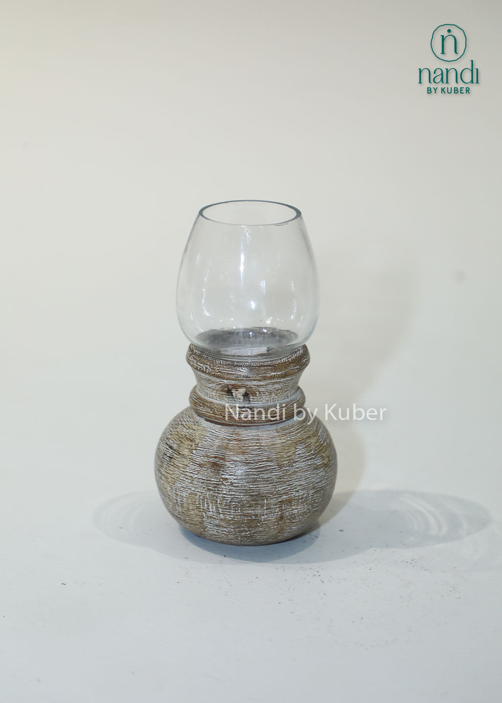 Wooden matki candle holder with clear glass shade, handcrafted decorative candle stand for home décor, table centerpiece, ambient lighting, festive decoration, rustic styling, and elegant living spaces.