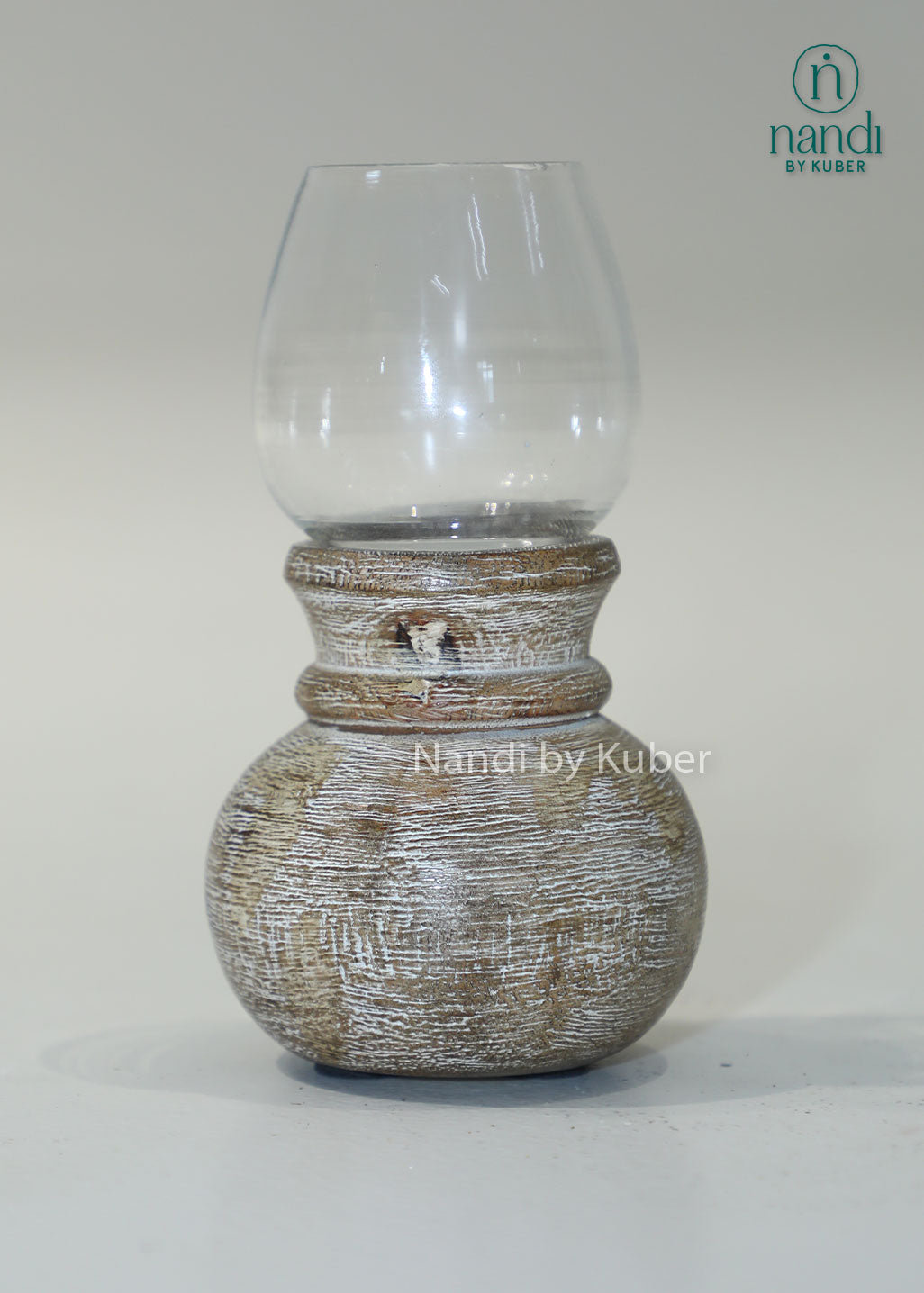 Wooden matki candle holder with clear glass shade, handcrafted decorative candle stand for home décor, table centerpiece, ambient lighting, festive decoration, rustic styling, and elegant living spaces.