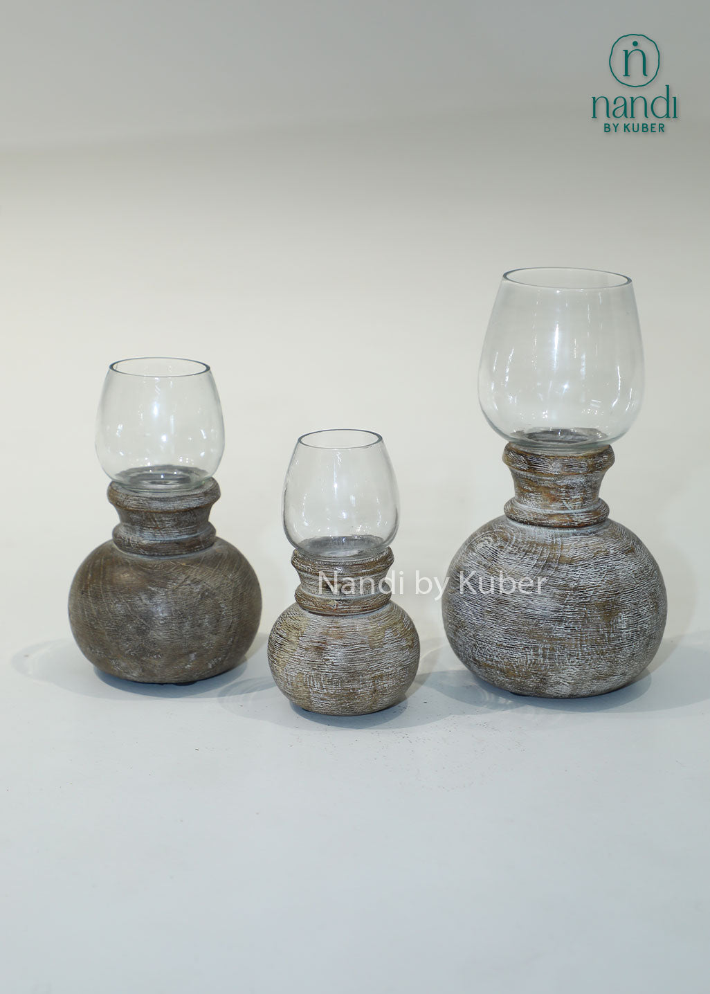 Wooden matki candle holder with clear glass shade, handcrafted decorative candle stand for home décor, table centerpiece, ambient lighting, festive decoration, rustic styling, and elegant living spaces.