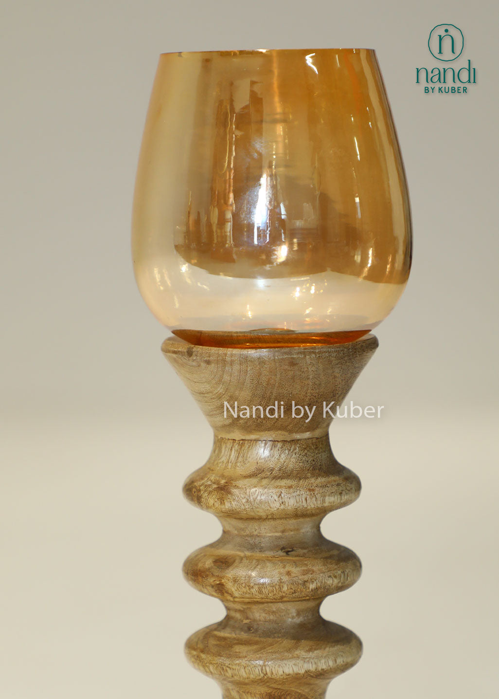 Decorative wooden candle stand with a spiral-turned base and amber glass shade, adding warmth and elegance to any interior setting.