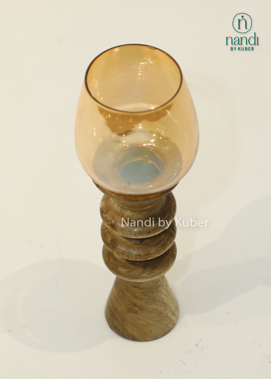 Decorative wooden candle stand with a spiral-turned base and amber glass shade, adding warmth and elegance to any interior setting.