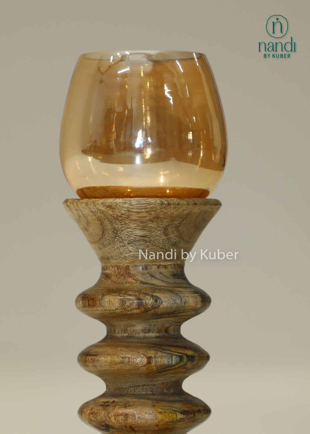 Decorative wooden candle stand with a spiral-turned base and amber glass shade, adding warmth and elegance to any interior setting.