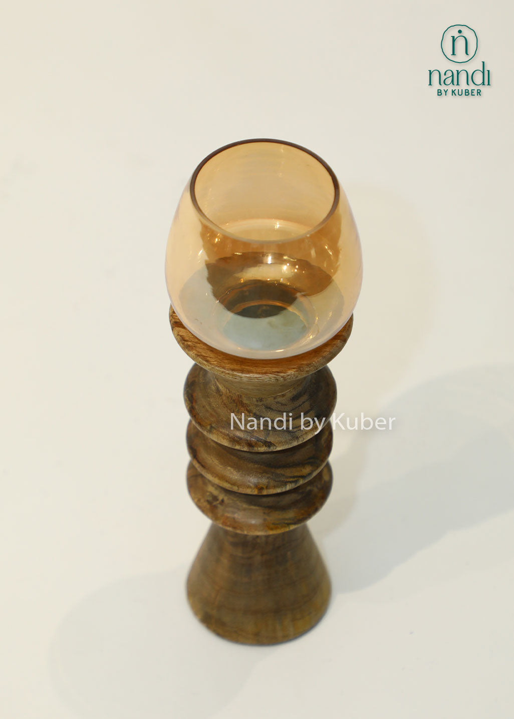 Decorative wooden candle stand with a spiral-turned base and amber glass shade, adding warmth and elegance to any interior setting.